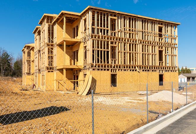 a job site enclosed by temporary chain link fences, ensuring safety for workers and pedestrians in New Smyrna Beach